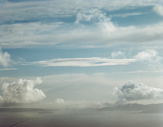 Color image of the Golden Gate Bridge on the horizon including the bay and sky