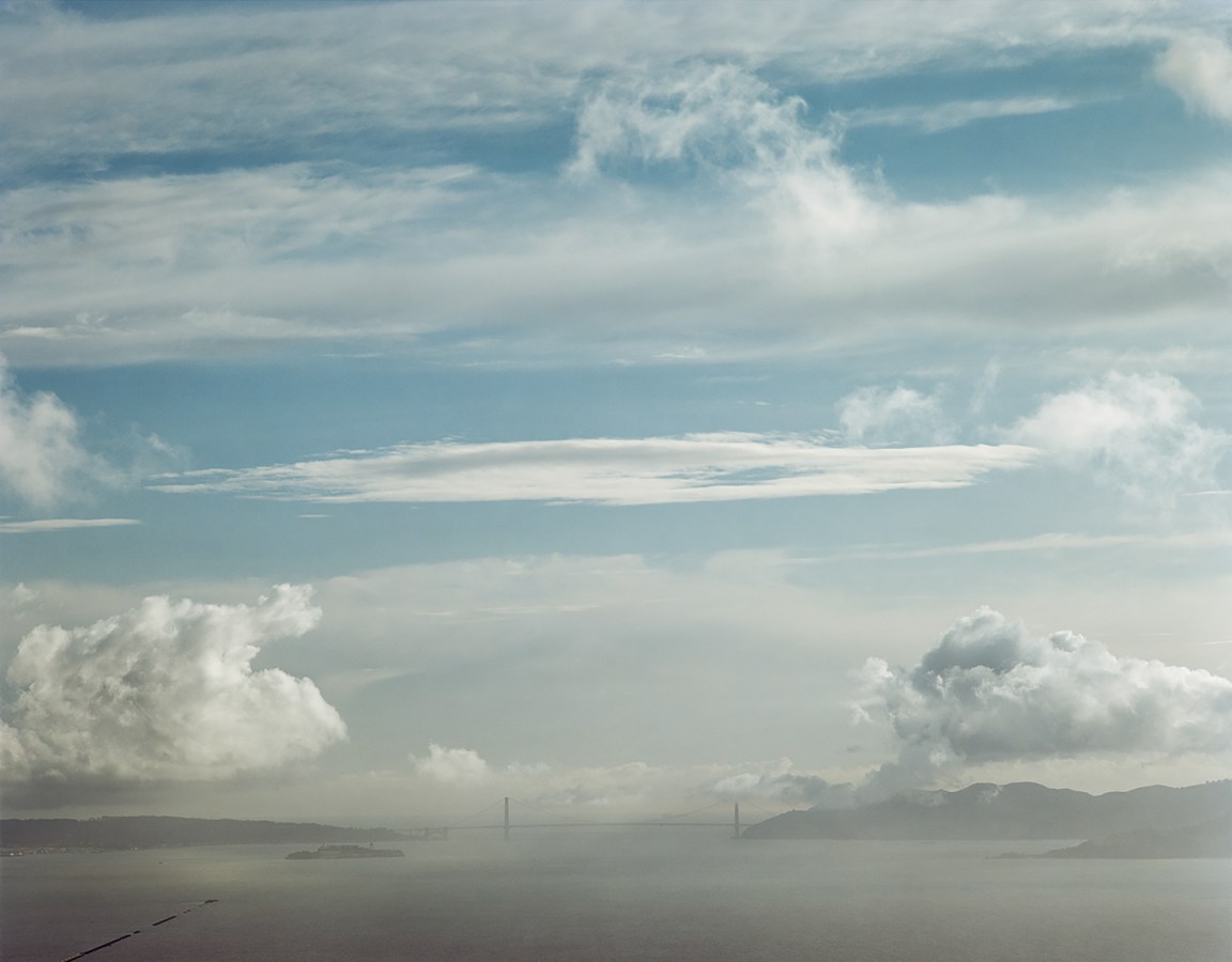 Color image of the Golden Gate Bridge on the horizon including the bay and sky