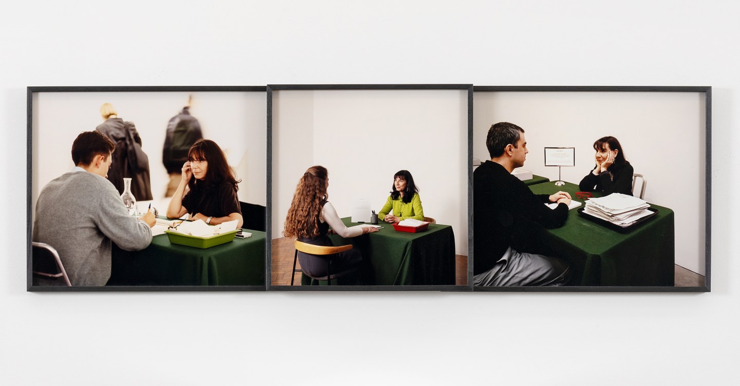 Color image of a triptych depicting three color photographs of two seated figures at a table