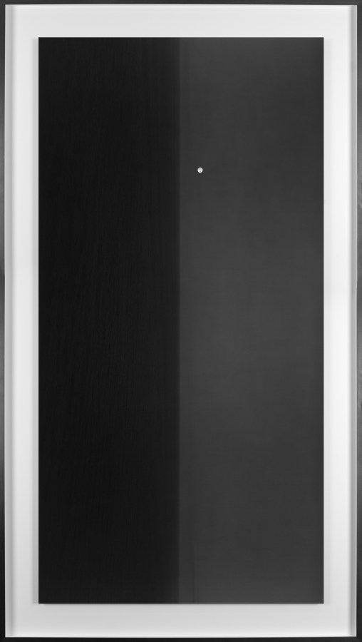 Black and white photograph of the ocean horizon with the moon slightly above the horizon line framed in black