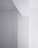 Photograph of a white ceiling and wall meeting